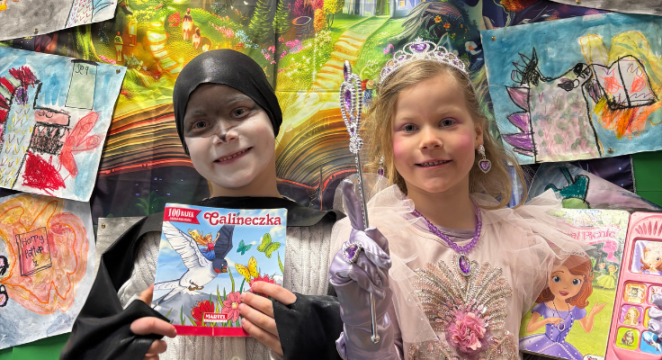 Two children dressed up for book week holding the books that inspired their costumes