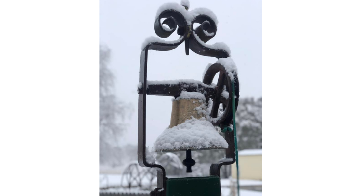 Our old-fashioned school bell covered in snow