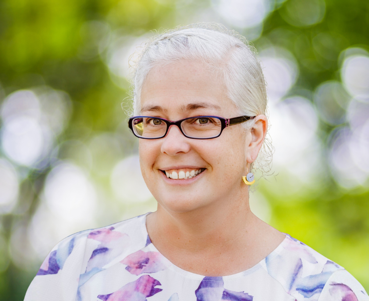 A photo of the current relieving school principal with a leafy background