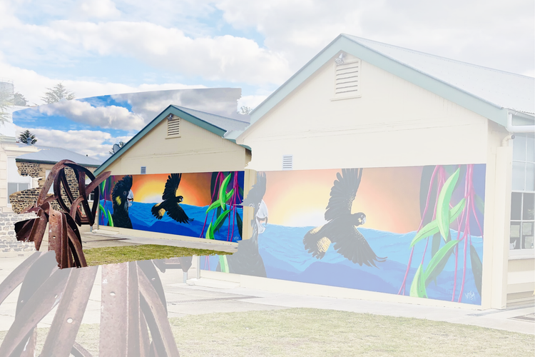 A banner style photo of one of the school's beautiful murals and a sculpture of a horse made of old fence posts, with the original school building to the left.